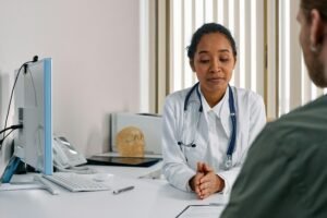 A female doctor consulting a patient in a modern medical office setting.